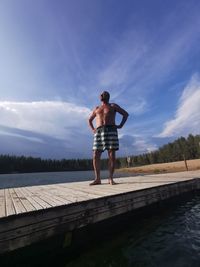 Rear view of woman standing on pier