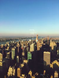 Aerial view of city buildings against clear sky