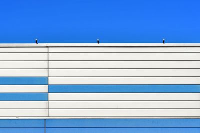 Low angle view of white building against clear blue sky