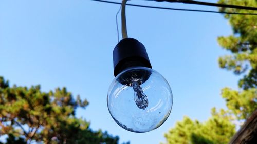 Low angle view of light bulb against sky