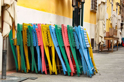 Multi colored umbrellas hanging on street amidst buildings