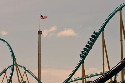 Low angle view of amusement park ride against sky