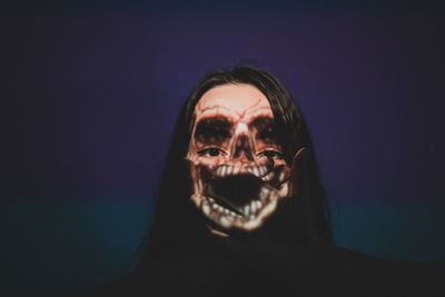 Digital composite image of spooky woman against blue background
