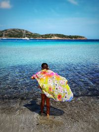 Rear view of person standing on beach