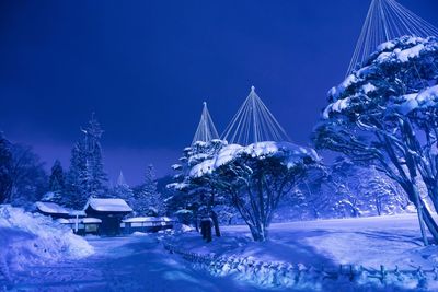 Snow covered trees against sky during winter