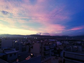 High angle view of illuminated buildings against sky at sunset