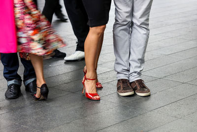 Low section of people standing on street