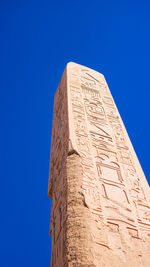 Low angle view of old building against clear blue sky