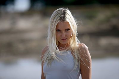 Portrait of a beautiful young woman standing outdoors