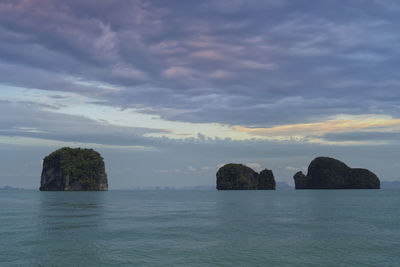 Scenic view of rocks in sea against sky