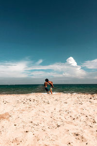 Man on beach against sky