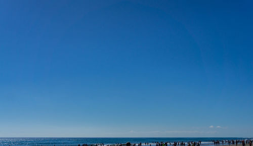 Scenic view of sea against clear blue sky