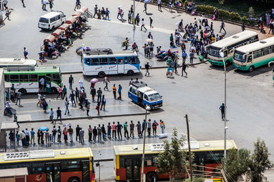 High angle view of people walking on road in city