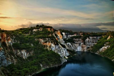 Scenic view of river amidst mountains against sky