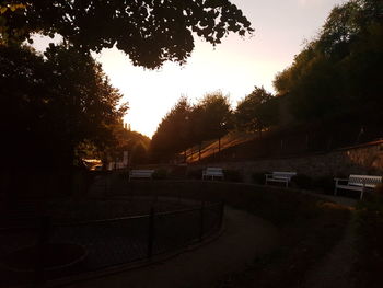 Cars on road against sky during sunset