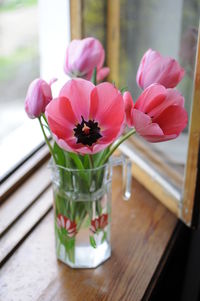 Close-up of pink flower vase on table