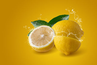 Close-up of lemon against orange background