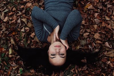 Portrait of beautiful woman lying no field during autumn
