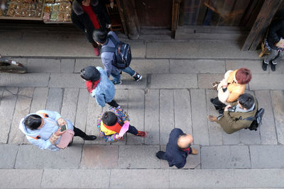 High angle view of people sitting on street