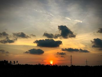 Silhouette trees against sky during sunset