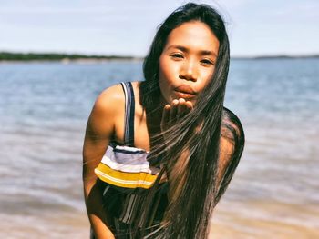 Portrait of teenage girl standing on beach