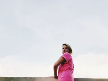 Portrait of woman standing against clear sky