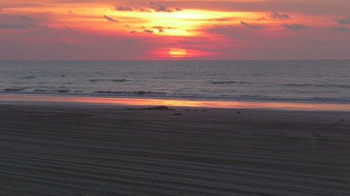 Scenic view of beach against sky during sunset