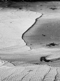 High angle view of shadow on sand at beach