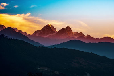 Scenic view of mountains against sky during sunset