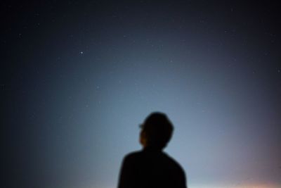 Low angle view of star field with man in foreground