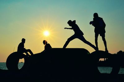 Silhouette of people at sunset