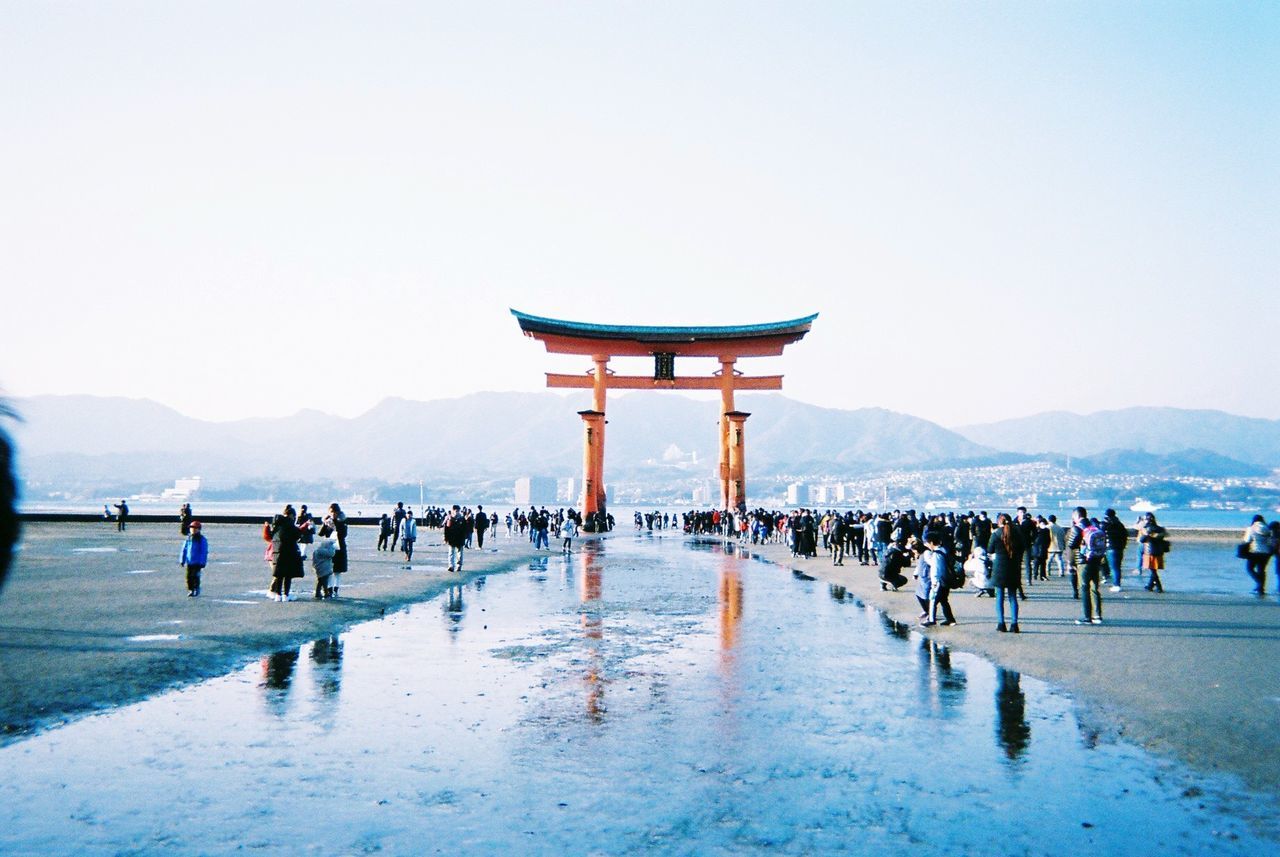 group of people, large group of people, crowd, sky, real people, water, travel destinations, nature, clear sky, men, architecture, mountain, travel, tourism, day, lifestyles, women, built structure, outdoors