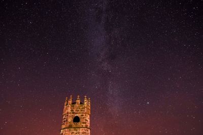 Low angle view of castle against sky at night