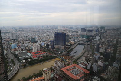 High angle view of city buildings against sky