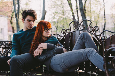 Young couple sitting outdoors