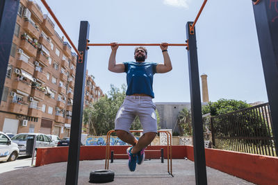 Full length of woman exercising in playground