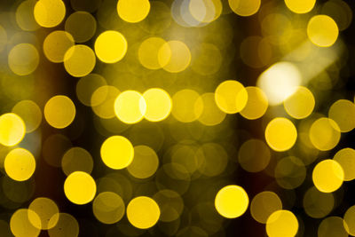 Defocused image of illuminated christmas lights at night