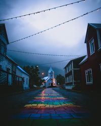 Road amidst buildings against sky in city