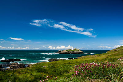 Scenic view of sea against blue sky