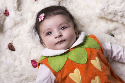 Portrait of cute baby lying on bed