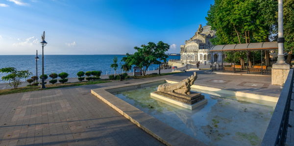 View of swimming pool by sea against sky