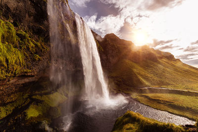 Scenic view of waterfall against rocks