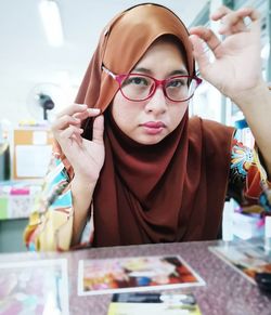 Portrait of happy girl with eyeglasses on table