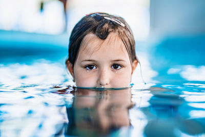 Portrait of girl swimming in pool