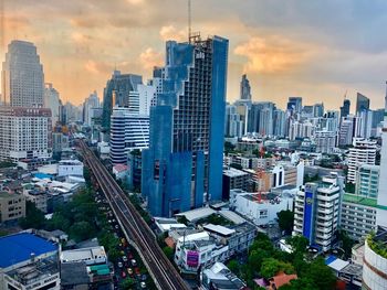 High angle view of buildings in city against sky during sunset