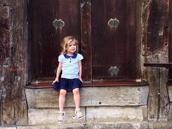 Portrait of a young woman on wooden wall