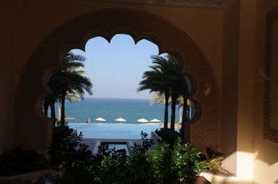 Scenic view of sea seen through arch