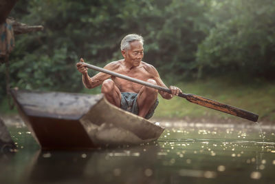 Midsection of man holding water