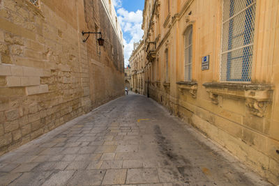 Empty road amidst buildings in town, medina, malta