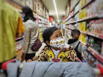 A girl and and people behind her at store